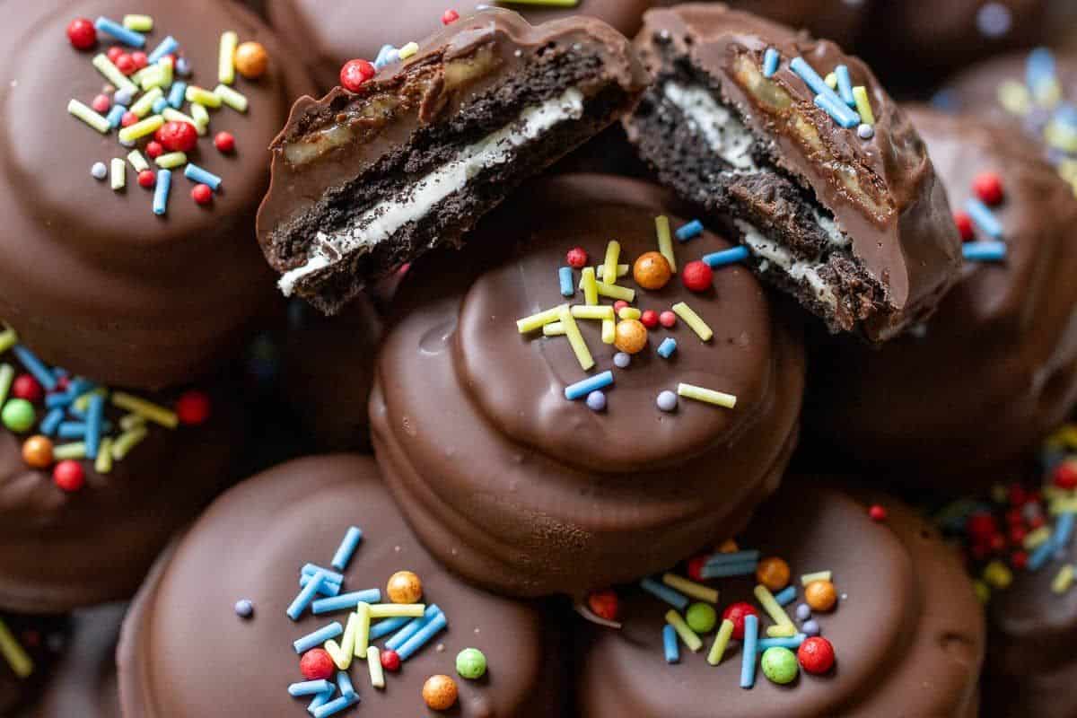 Chocolate covered oreos with sprinkles.