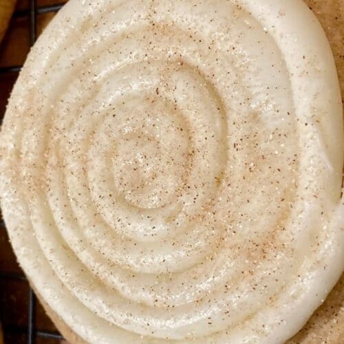 Crumbl Snickerdoodle Cupcake Cookie with frosting on wire mesh