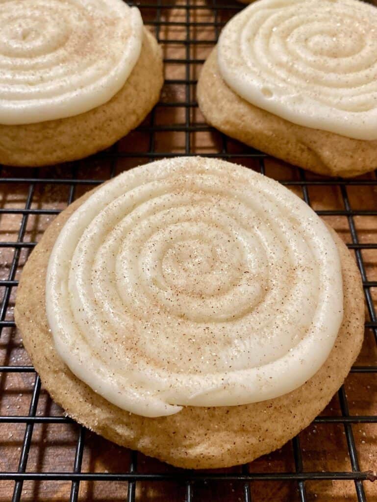 Crumbl Snickerdoodle Cupcake Cookie with frosting on wire mesh