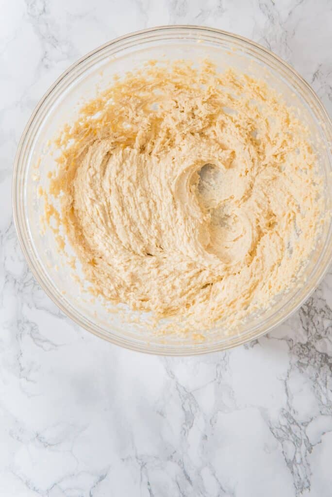 A bowl with Sour Cream Brown Butter Cookies creamy and smooth ingredients