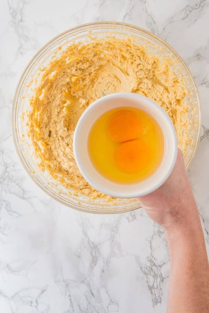 Add eggs to the creamy mixture ingredients in a bowl