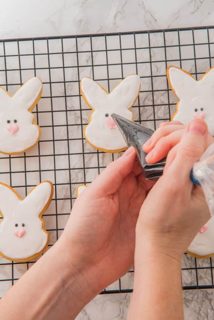 Draw eyes on Easter Cookies on wire mesh