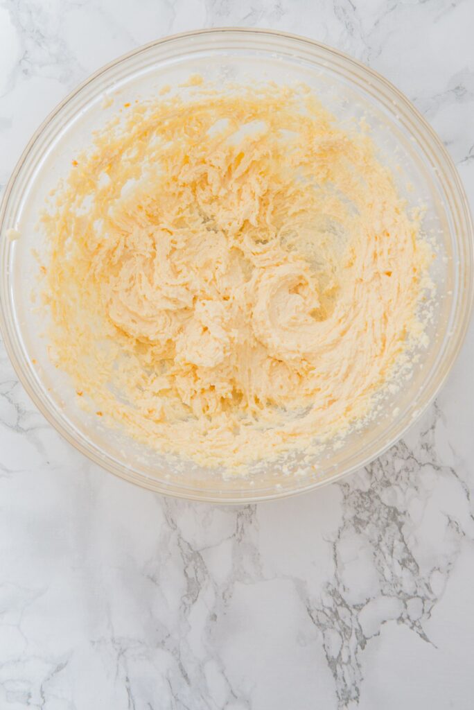 In a large bowl, beat the butter, sugar, and vanilla extract until light and creamy.