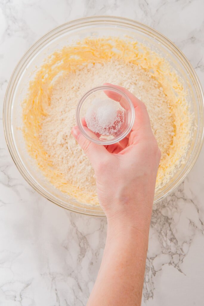 Add baking powder to creamy batter of Wicked Themed Birthday Cookies