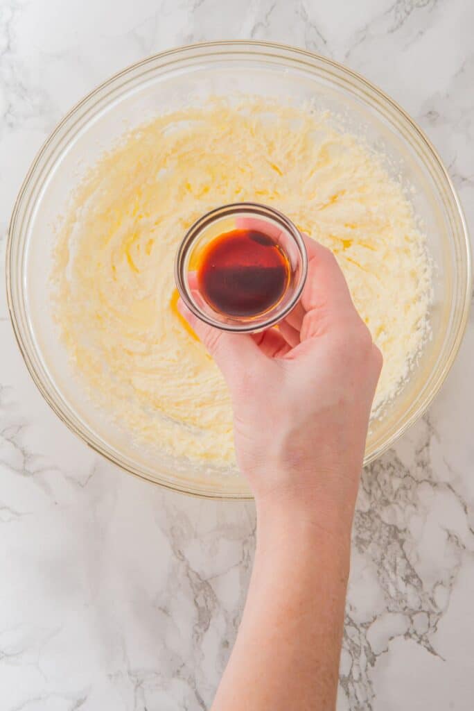 Add vanilla extract into creamy batter of Wicked Themed Birthday Cookies