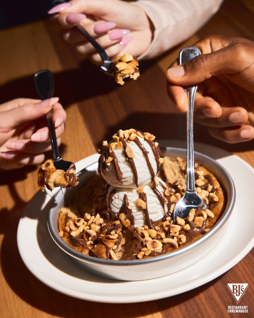 BJ's Nutella Gone Bananas Pizookie, a banana bread cookie topped with two scoops of vanilla bean ice cream, a Nutella drizzle and crushed hazelnuts.