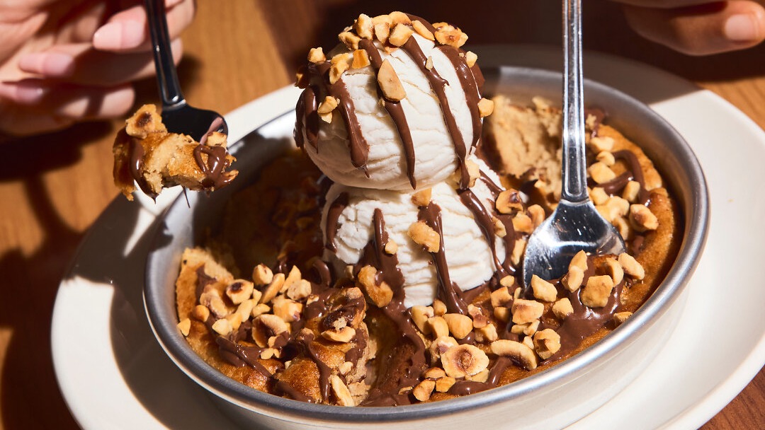 BJ's Nutella Gone Bananas Pizookie, a banana bread cookie topped with two scoops of vanilla bean ice cream, a Nutella drizzle and crushed hazelnuts.